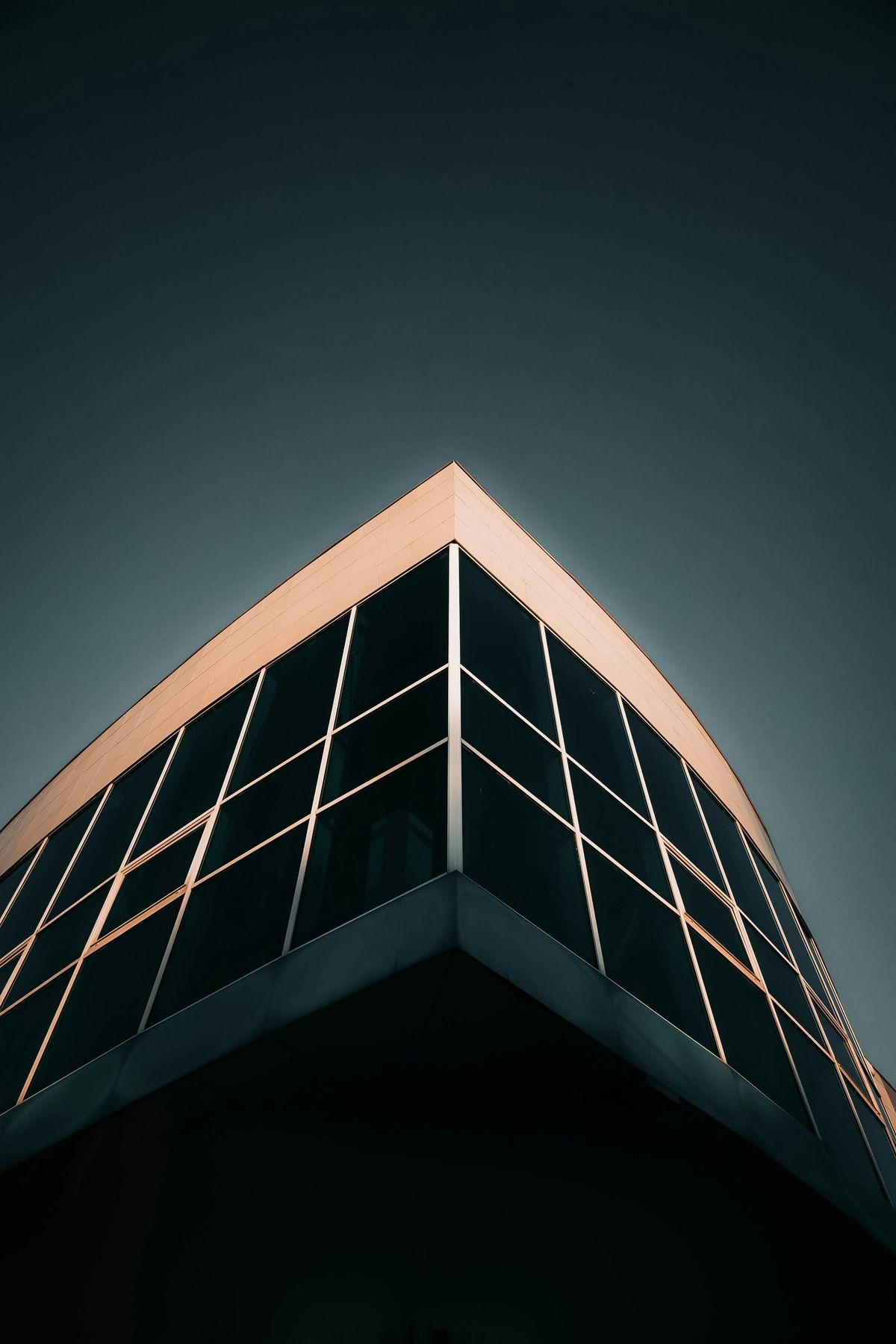 Modern dark glass building representing North West construction marketing
